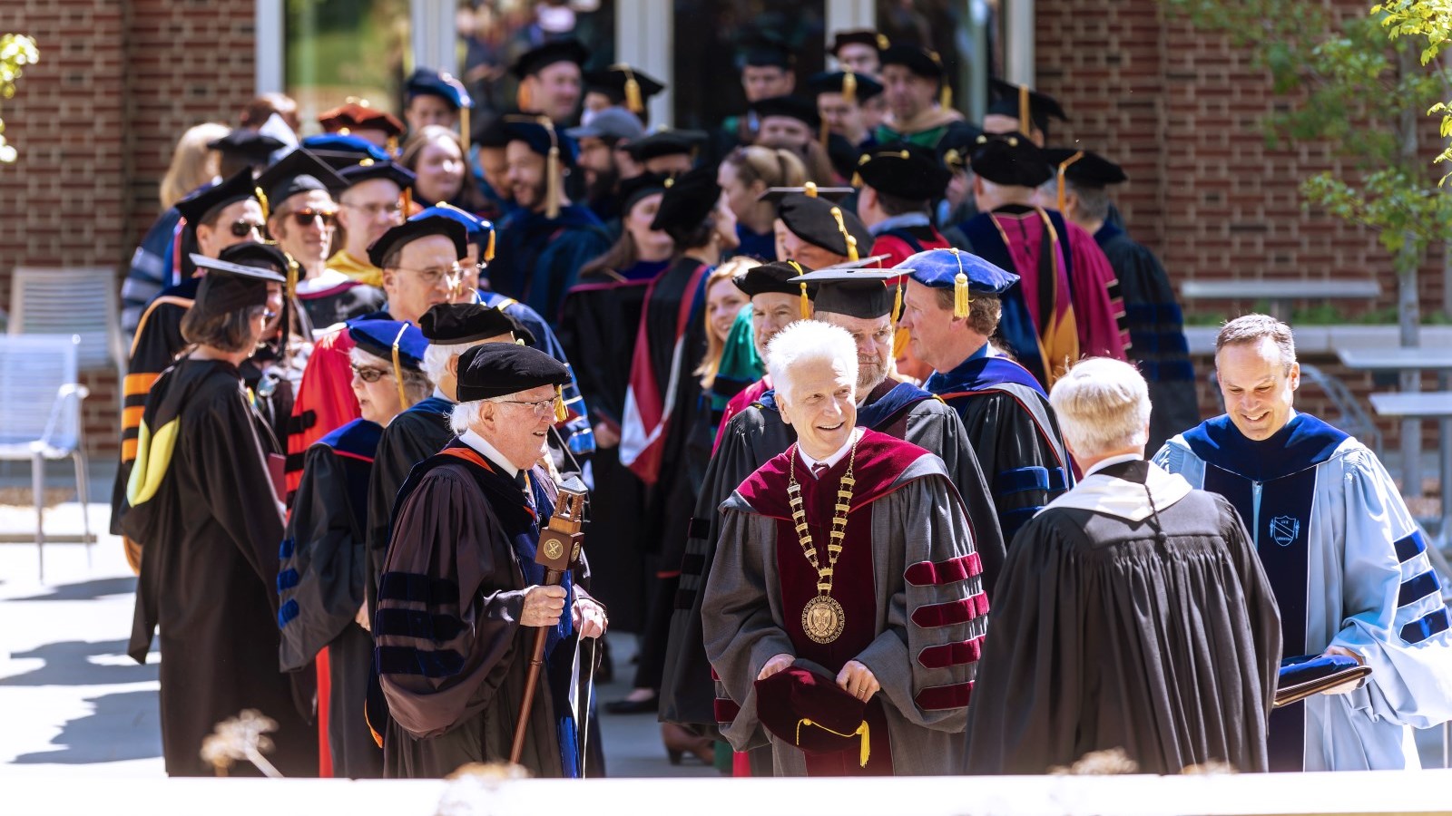 faculty and adminstration in regalia at a ceremony