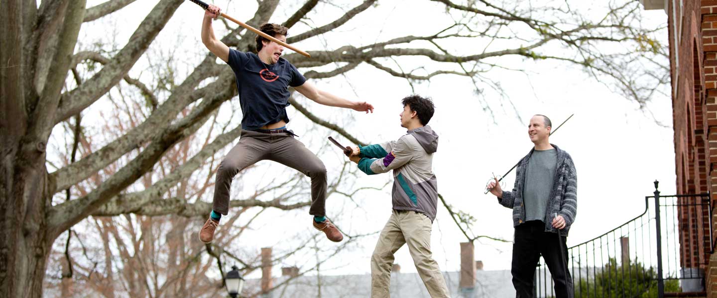 Students practicing swordplay outdoors at Hampden-Sydney