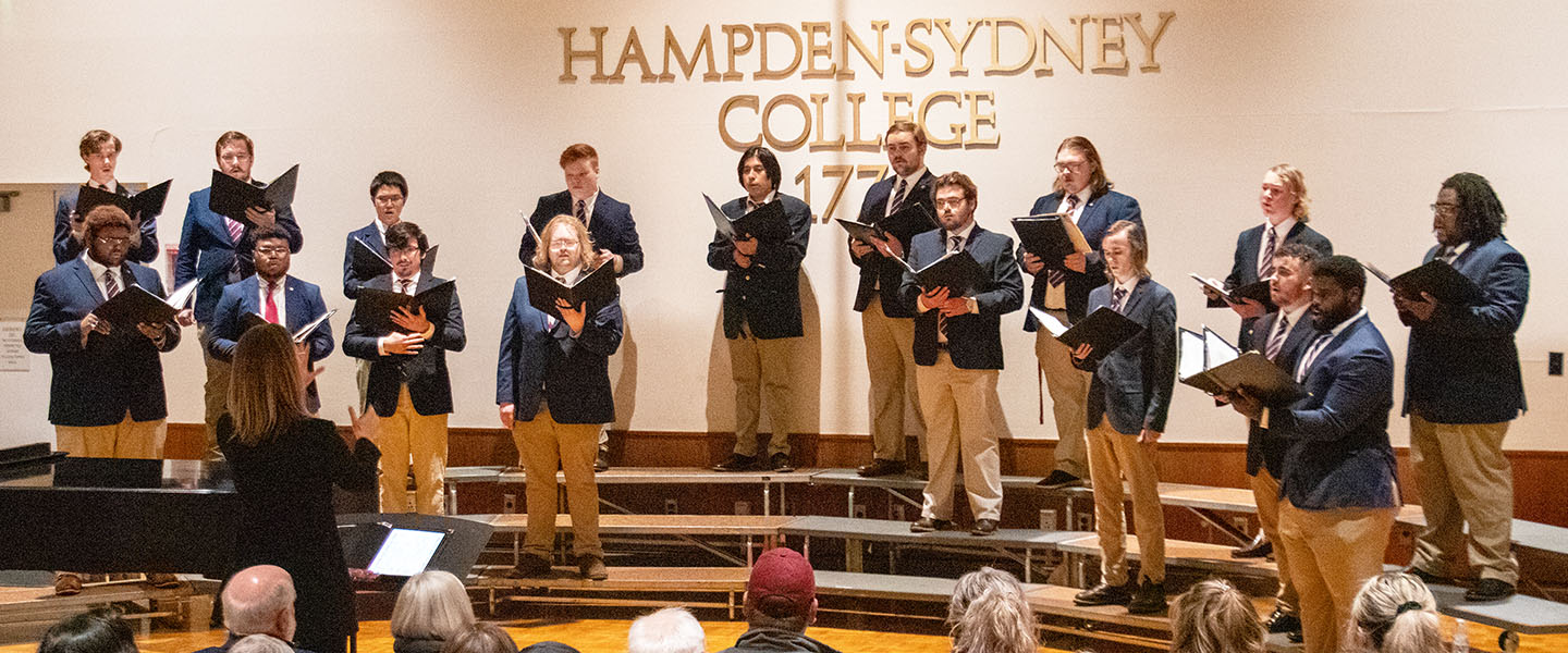 The H-SC Men's Chorus singing on risers inside Crawley Forum performance space