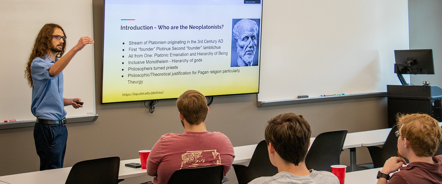 a student giving a Philosophy presentation to his classmates