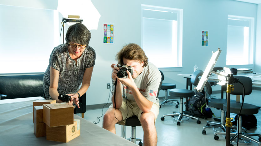 Professor Fox and photography student in the photography studio