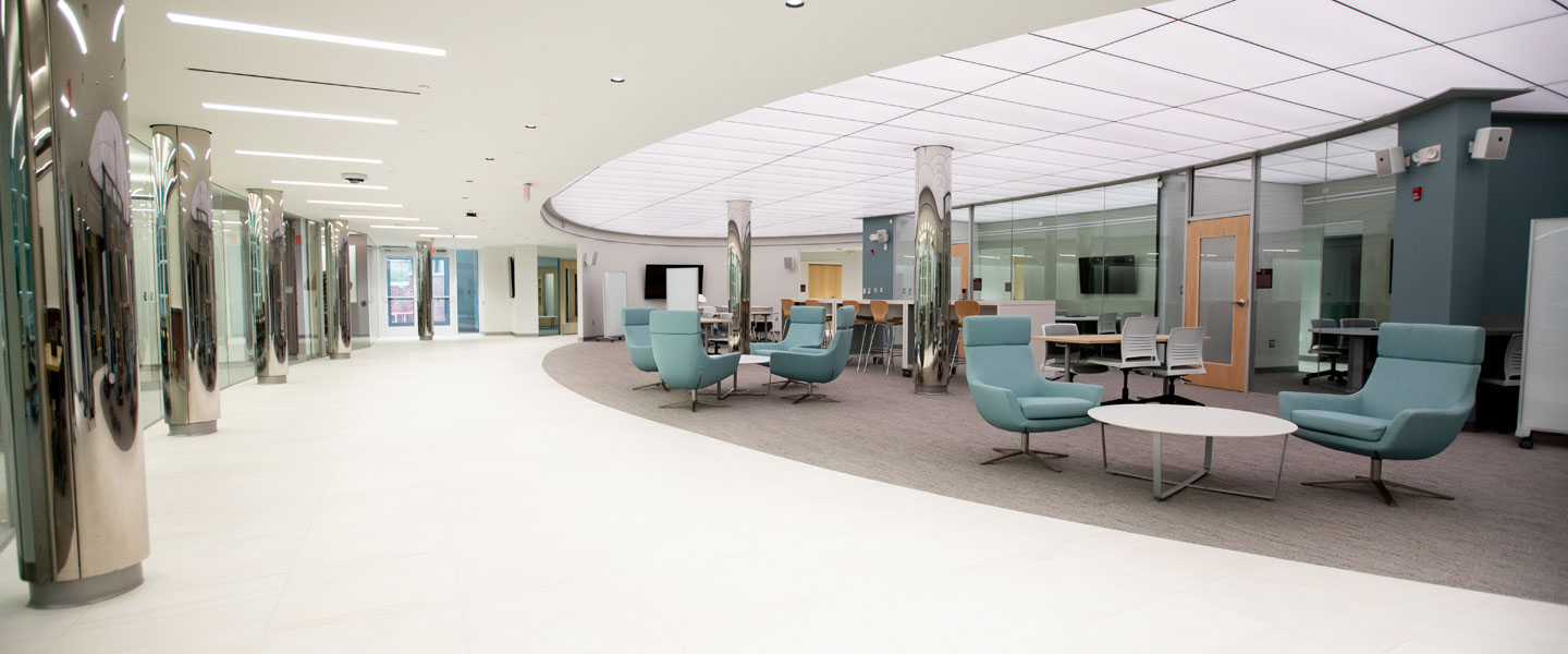 Tables and chairs sit in the Birdsong Atrium