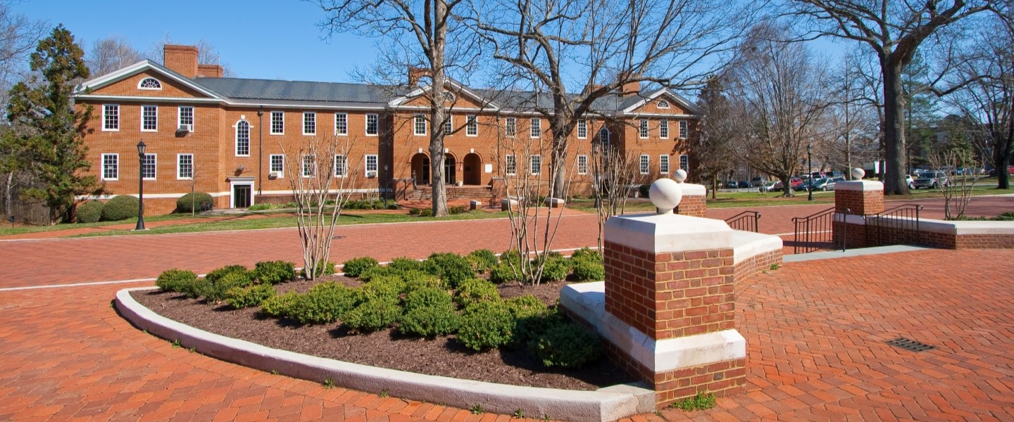 Gilmer Hall, a brick academic building, in winter