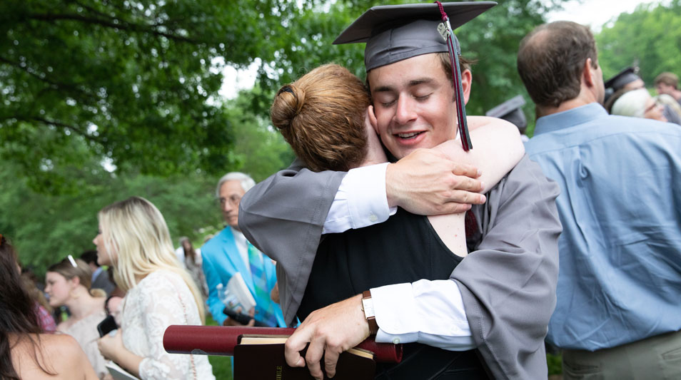 Hampden-Sydney College graduate hugging his parent at Commencement 2019