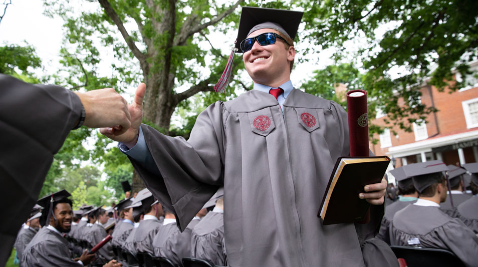 Smiling Hampden-Sydney College graduate with degree at Commencement 2019