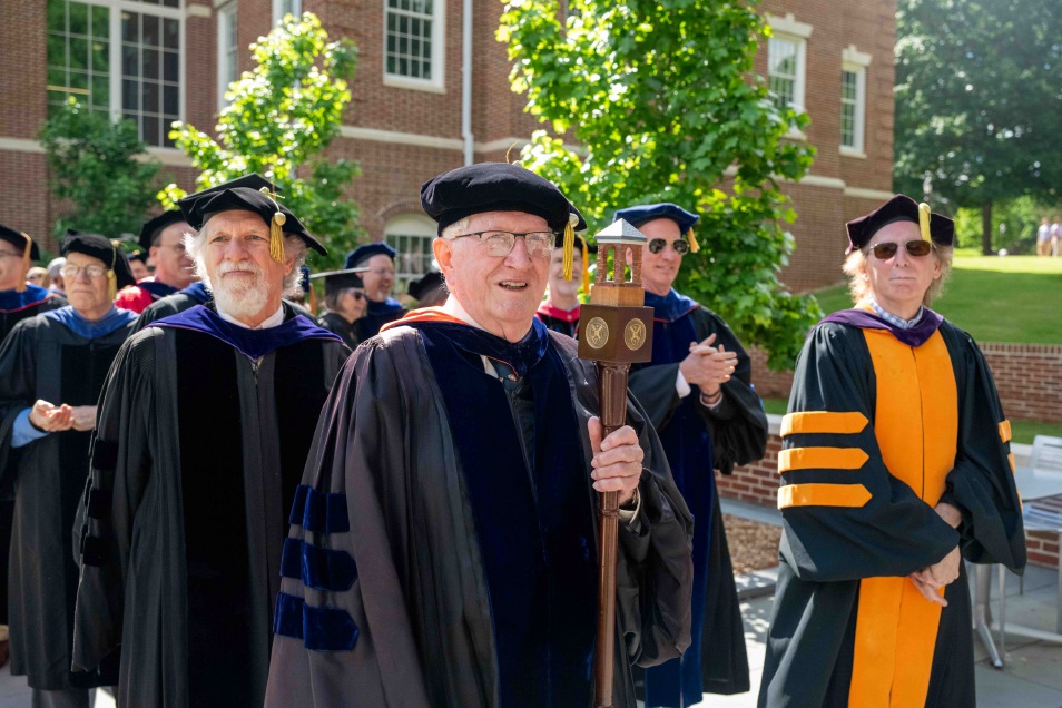 Commencement 2024 faculty in regalia processing at the ceremony
