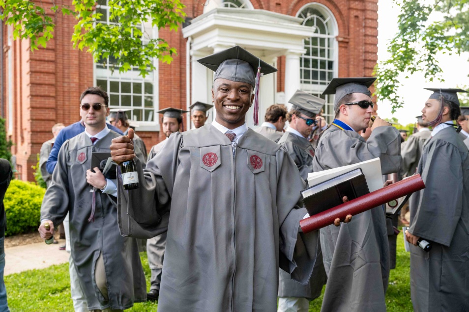 excited graduates leaving commencement
