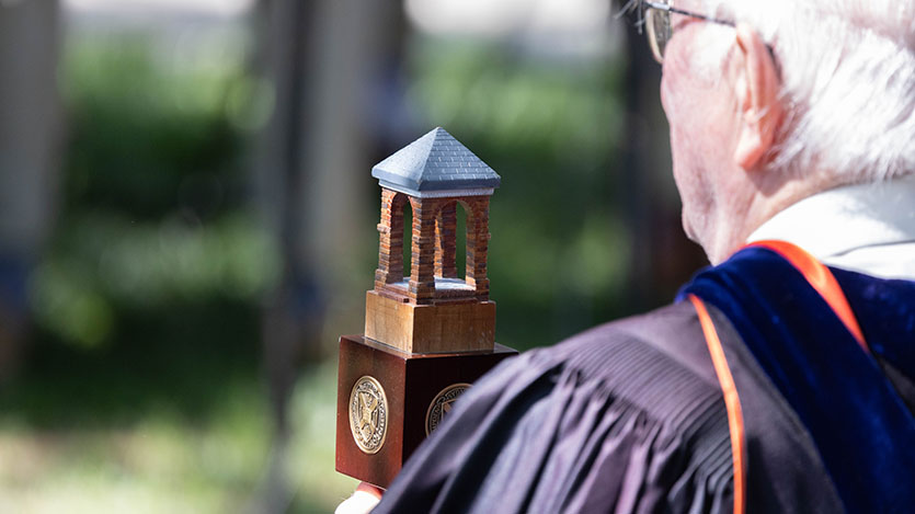 the faculty magistrate carrying the ceremonial mace at commencement