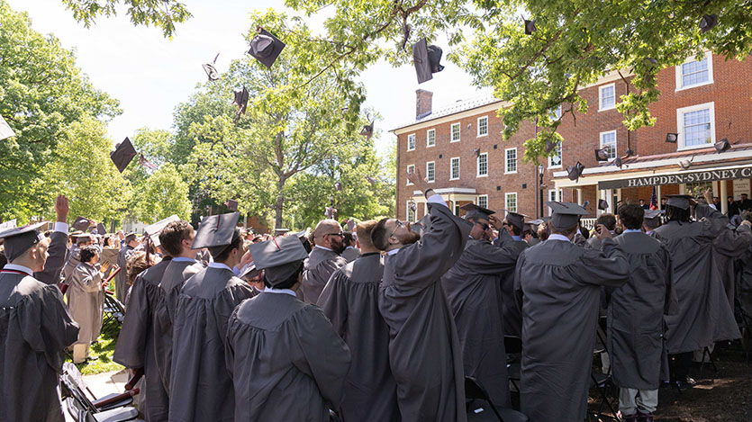 graduates tossing their caps at the end of the ceremony