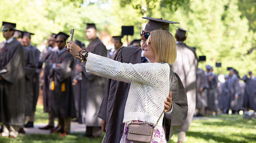 a mother and graduate taking a selfie at commencement