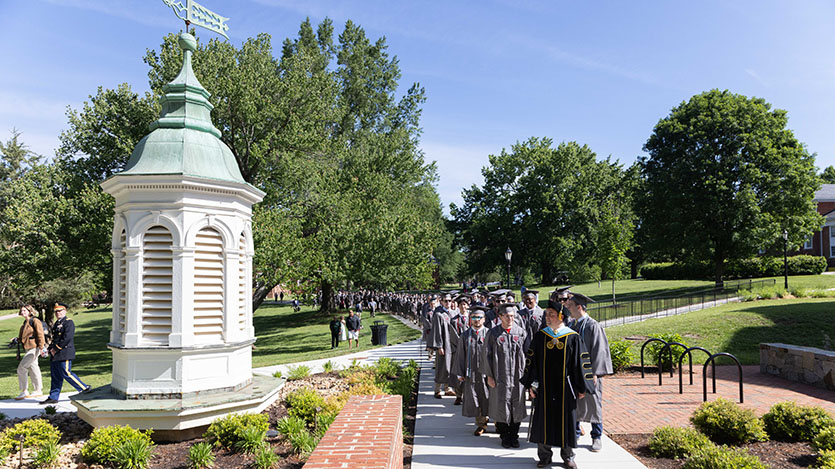 graduates processing in front of the Bagby cupola