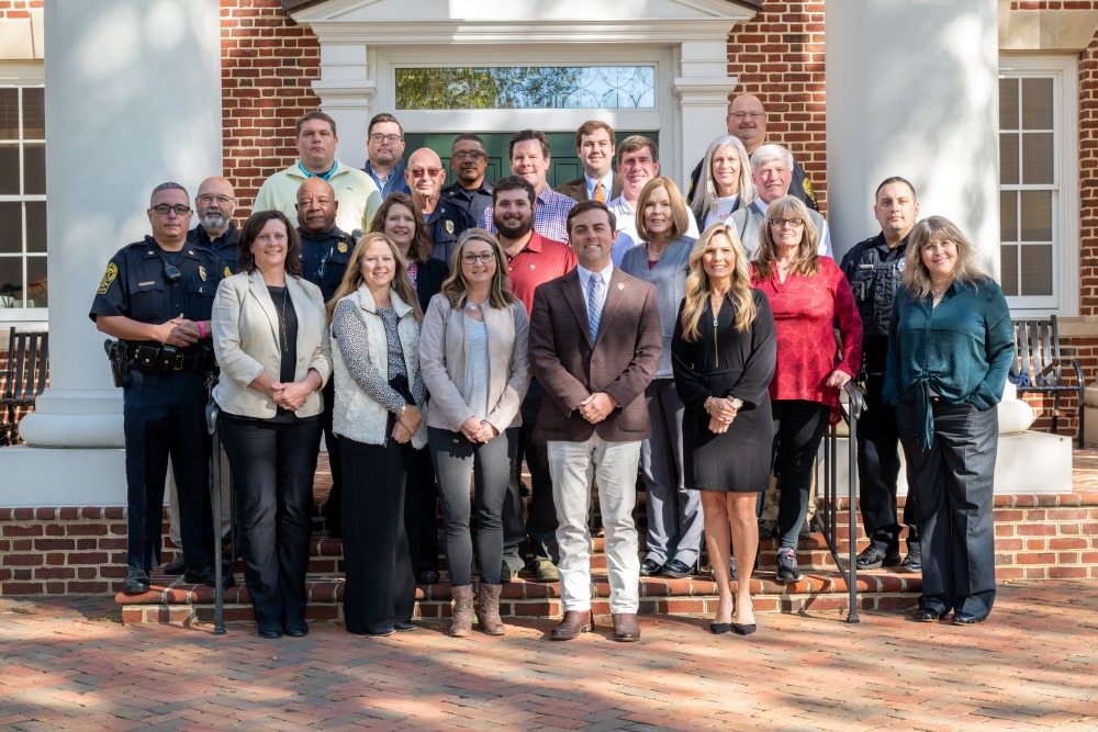 The entire student affairs staff standing in a group in front of Brown Student center