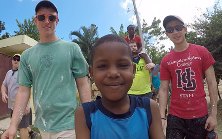 Tanner Beck '18 and Jacky Cheng '18 with a local child in the Dominican Republic.