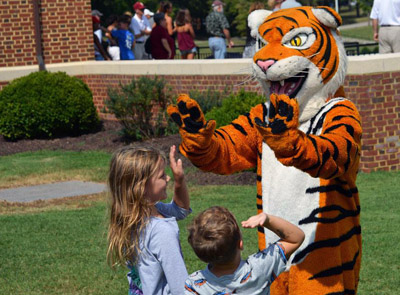 Yank the Tiger gives kids a high five at a football game.