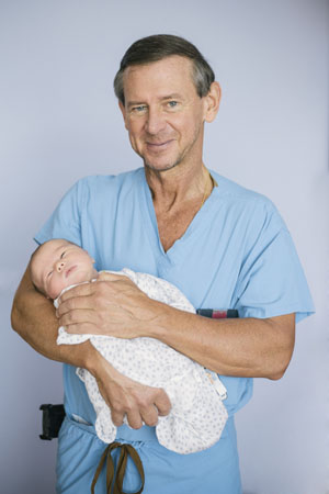 Dr. Edward Wolanski '78 with a newborn