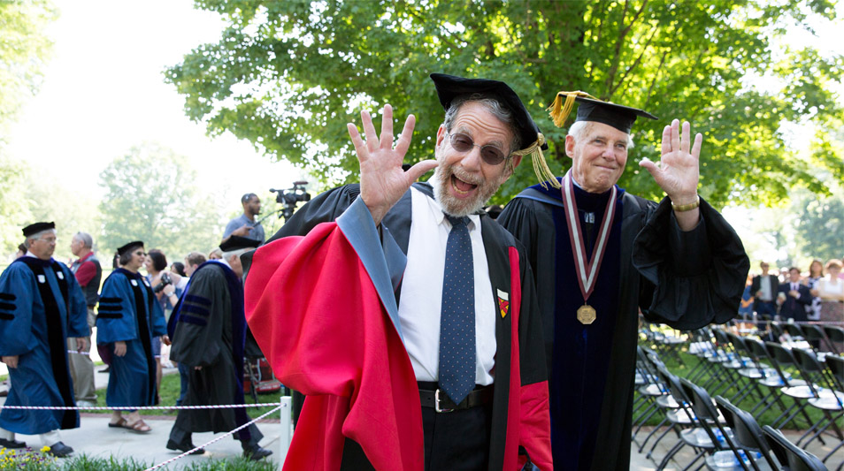 Professors Arieti and Heinemann wave during the commencement procession.