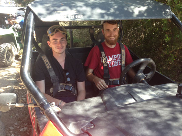 Austin Senecal with a friend in an ATV in Jerusalem.