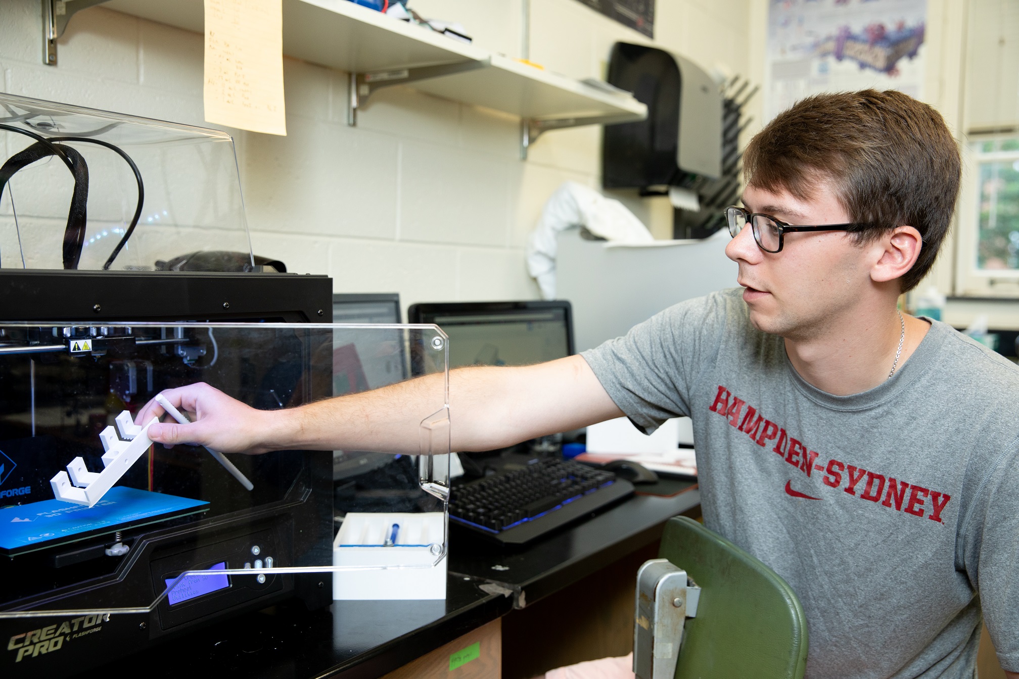 Andrew Howell uses the 3D printer in the lab
