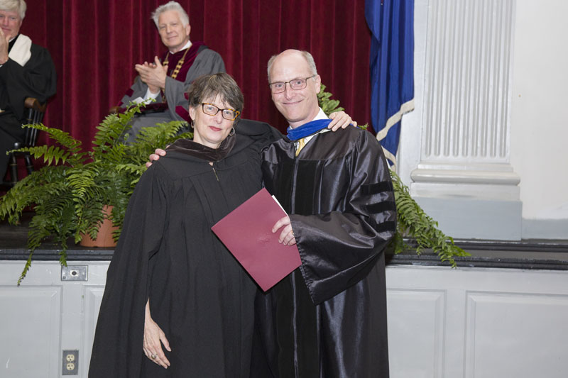Pam Fox receives an award from Mike McDermott at Convocation