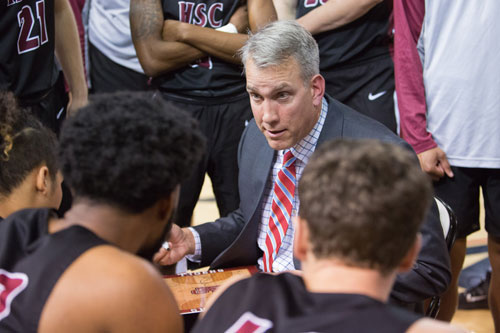 Hampden-Sydney Head Coach Dee Vick talking with basketball team