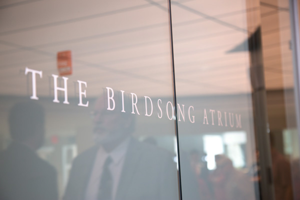 a glass wall that reads "The Birdsong Atrium"