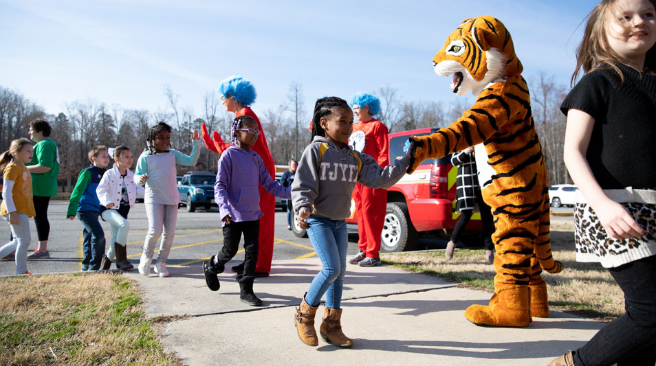  Staff dressed as the Hampden-Sydney Tiger greets elementary students