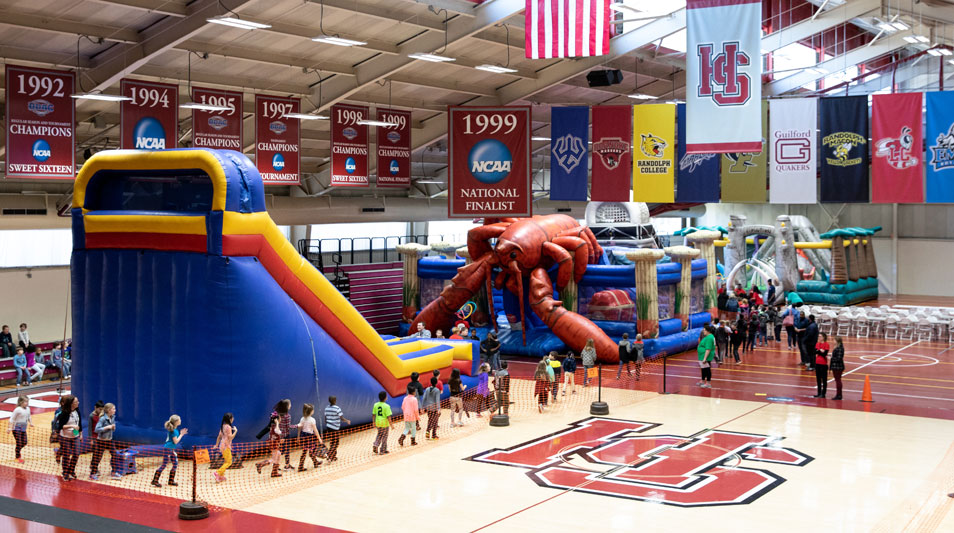 Bounce Houses and games set up in the Hampden-Sydney gym