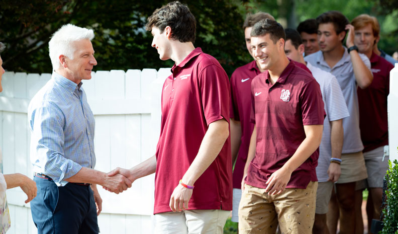 Stimpert shakes hands with new students