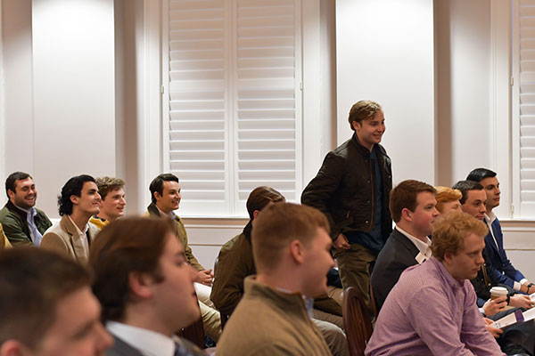 A student in the crowd asks a question to the alumni panel.
