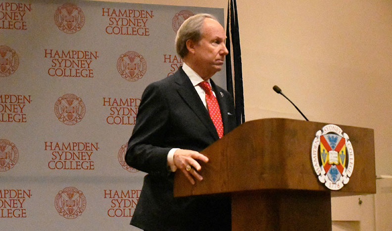 Hon. Paul Trible '68 standing at a podium
