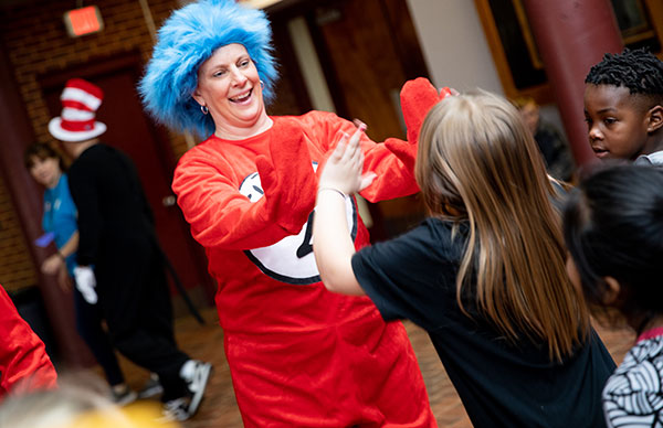 Dr. Seuss's "Thing 1" high fiving a child