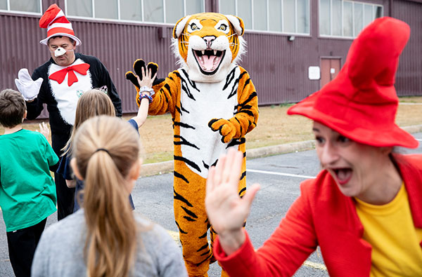 Dr Seuss characters high-fiving students from local schools
