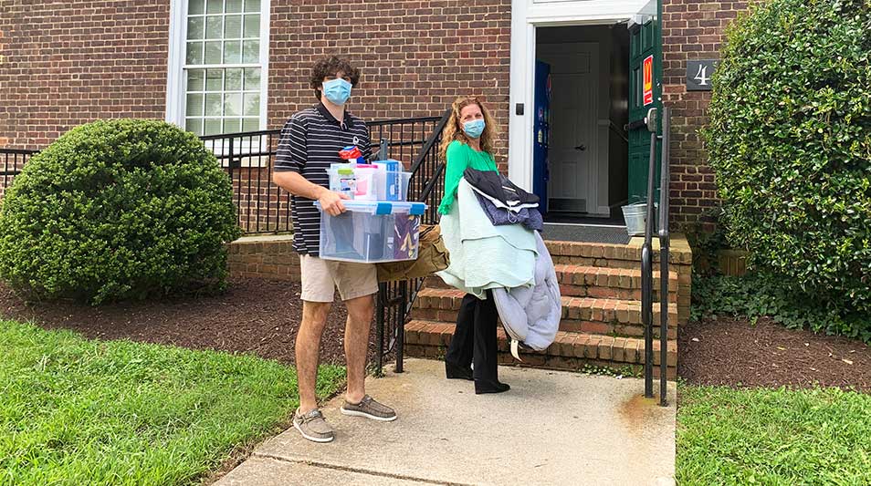 a student and his mother moving into his dorm