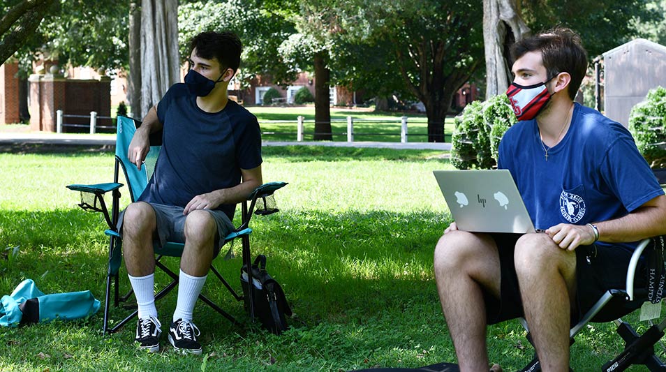 students sitting outdoors for class