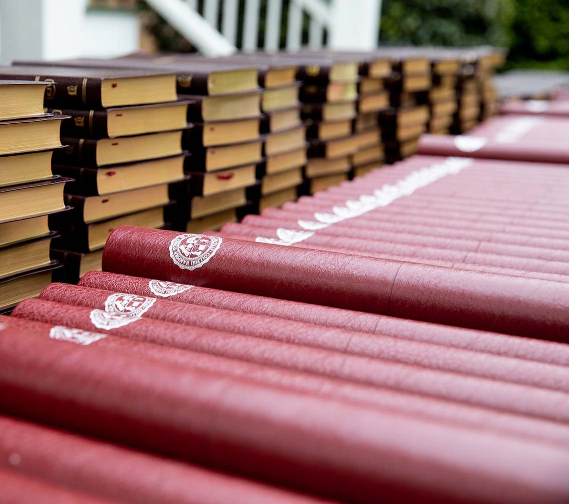 Bibles and diplomas stacked neatly on a table