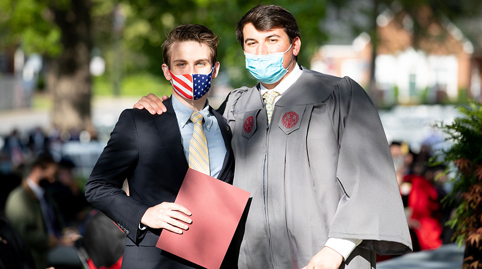 Hampden-Sydney students in regalia posing for a photo