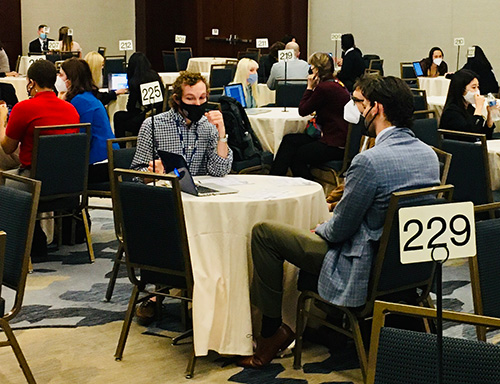 Coleman Meadows at a table presenting his research