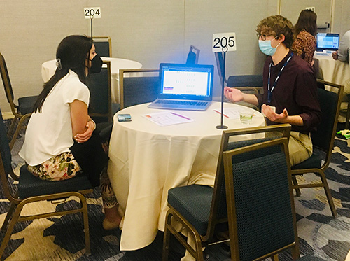 Jackson Eisele at a table presenting his research