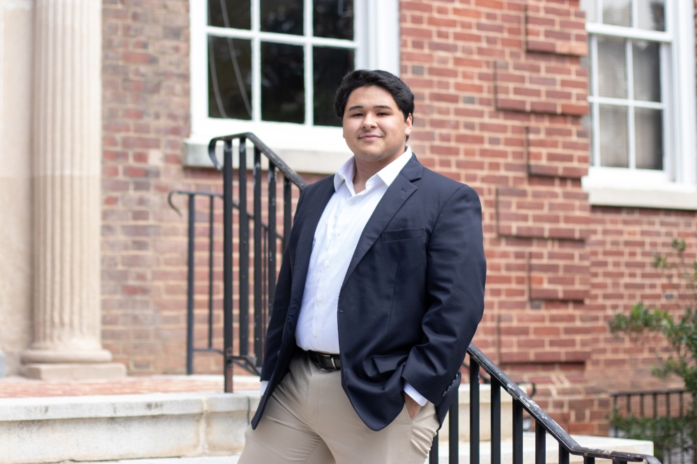 Elliot Williams' 25 standing in front of a campus building