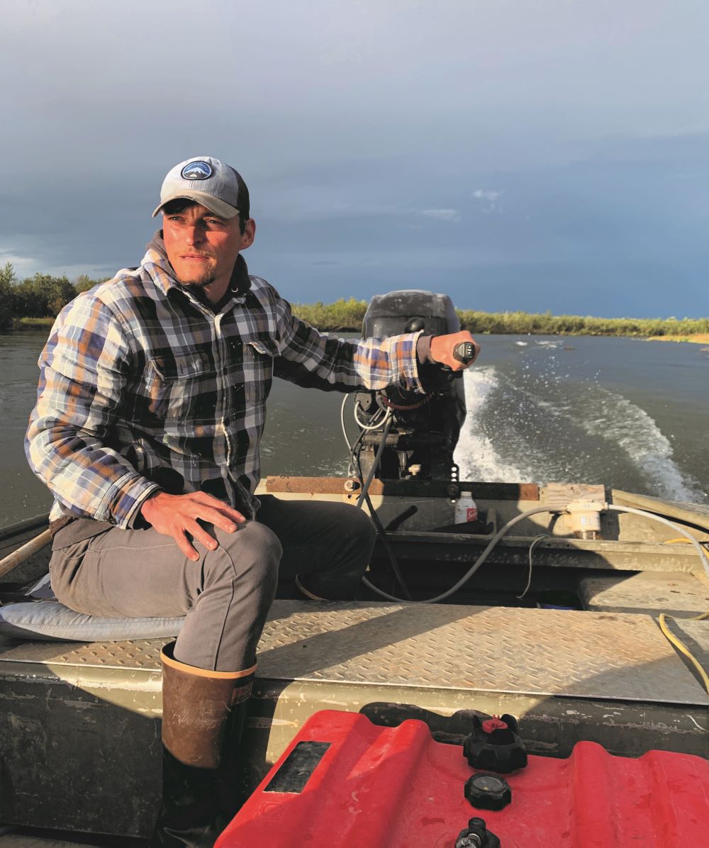 Dr. Sean Gleason manning a small boat on the ocean