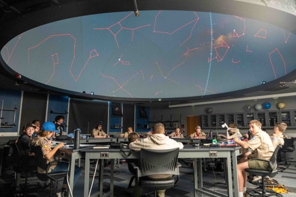 boy scouts in uniform in a planetarium