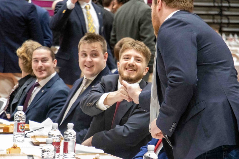 H-SC students shaking hands and having fun at the dinner table