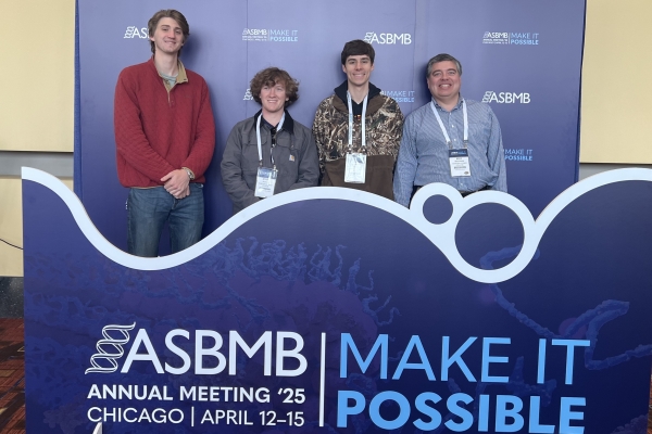 group photo of students posing at a conference