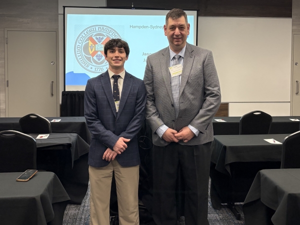 student and professor posing at a conference