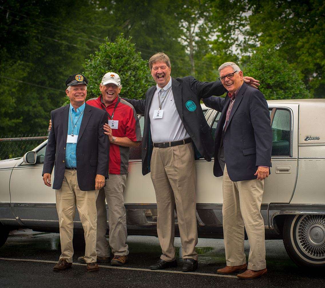 Charlie Cobb and friends in front of a limo