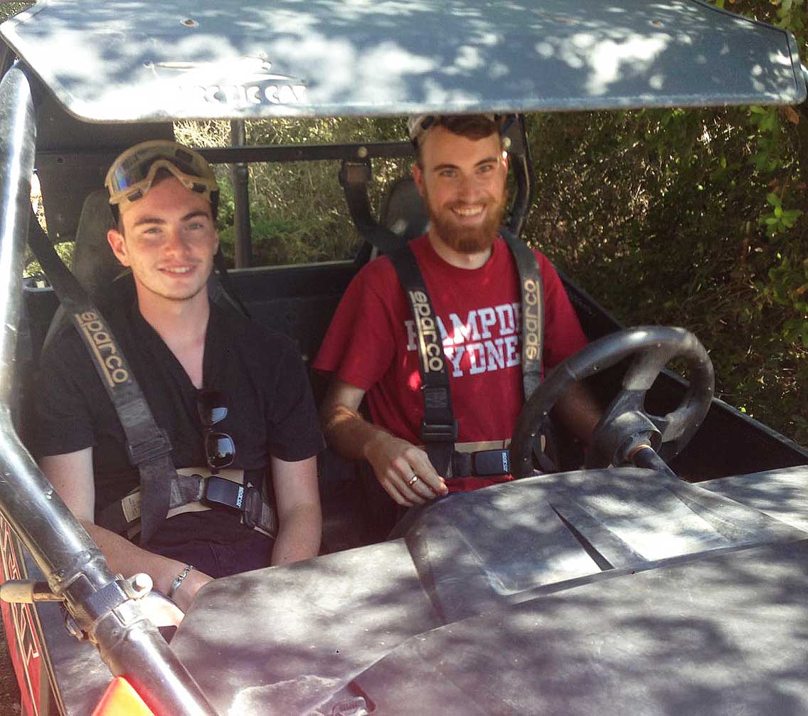 Austin Senecal with a friend in an ATV in Jerusalem.