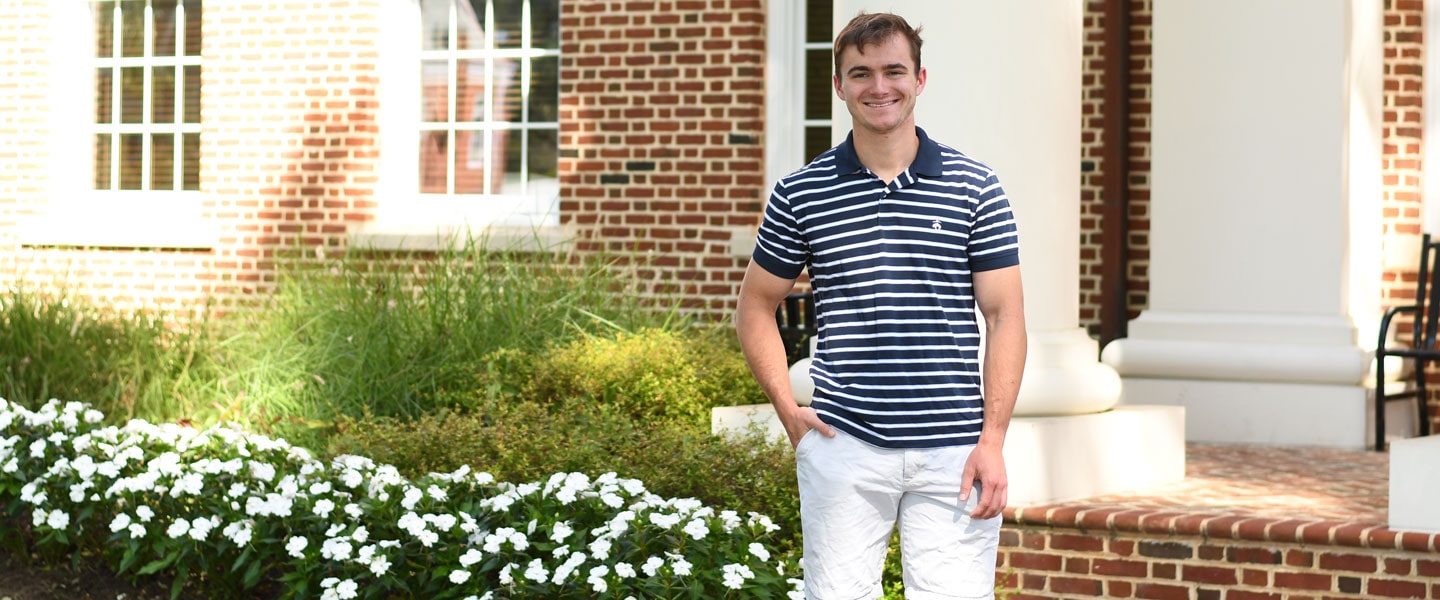 Alex Dent '21 standing in front of Brown Student Center building