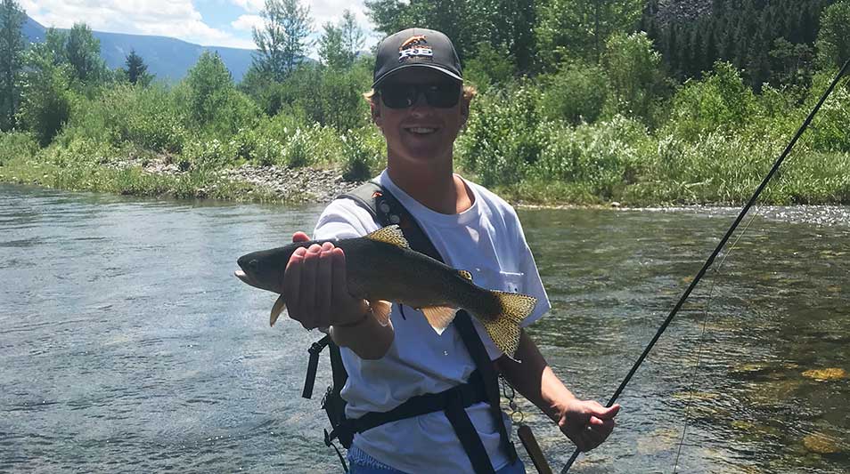 Butler Bennett '20 holding a Rainbow Trout 