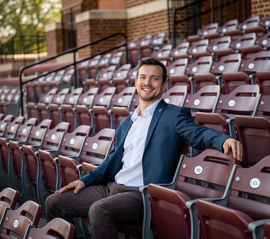 Mike Daum '23 sitting in a bleacher seat