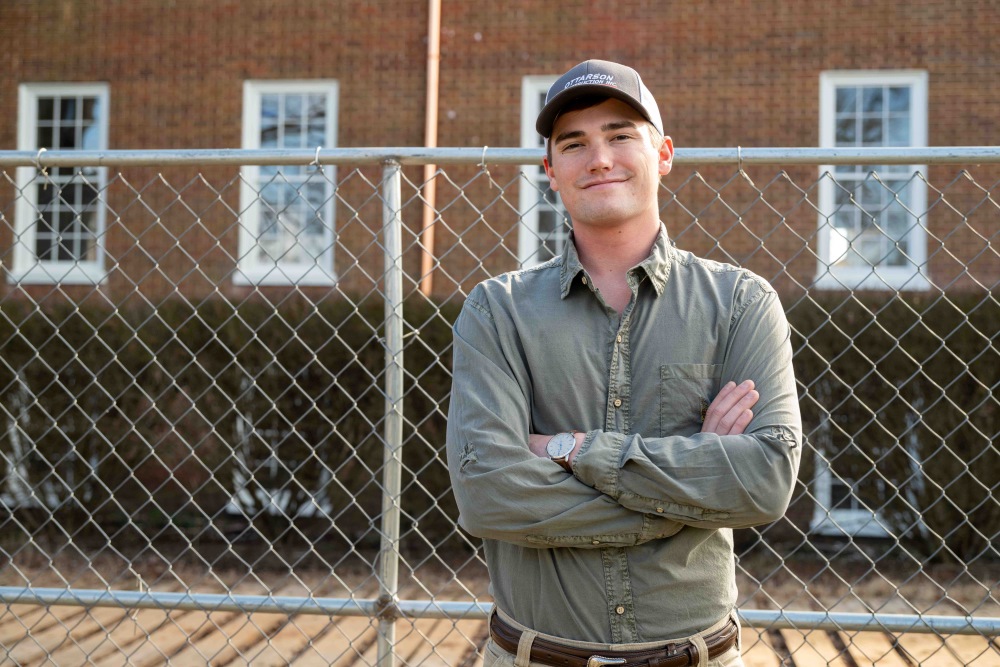 Drake James standing outside a construction site